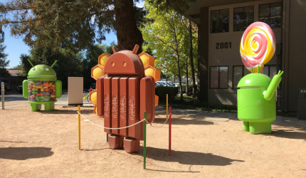 3 Android statuses in an outside yard